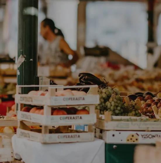 Puesto de mercado con cajas de fruta y verdura